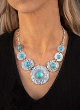 Load image into Gallery viewer, Dotted with refreshing turquoise stone centers, mismatched hammered silver frames gradually increase in size as they link below the collar for a fierce look. Features an adjustable clasp closure.