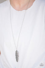 Load image into Gallery viewer, Glittery hematite rhinestones are encrusted down the spine of a life-like silver feather. The whimsical pendant swings from the bottom of a lengthened silver chain for a seasonal look. Features an adjustable clasp closure.  Sold as one individual necklace. Includes one pair of matching earrings.  Always nickel and lead free.