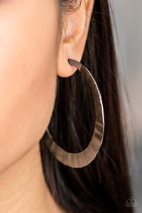 Brushed in a high-sheen finish, a delicately hammered silver hoop curls around the ear for a fierce look. Earring attaches to a standard post fitting. Hoop measures 2 1/2" in diameter.  Sold as one pair of hoop earrings. Always nickel and lead free.