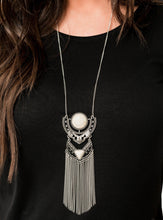 Load image into Gallery viewer,   Featuring refreshing white stone accents, ornate silver plates link at the bottom of a lengthened silver chain for a dramatic tribal look. Shimmery silver chains stream from the bottom of the stacked pendant, adding a wanderlust flair to the seasonal palette. Features an adjustable clasp closure.  Sold as one individual necklace. Includes one pair of matching earrings.