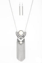 Load image into Gallery viewer,   Featuring refreshing white stone accents, ornate silver plates link at the bottom of a lengthened silver chain for a dramatic tribal look. Shimmery silver chains stream from the bottom of the stacked pendant, adding a wanderlust flair to the seasonal palette. Features an adjustable clasp closure.  Sold as one individual necklace. Includes one pair of matching earrings.