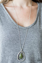 Load image into Gallery viewer, A green bead is pressed into the center of a delicately hammered silver frame. The colorful teardrop swings from the top of a silver teardrop silhouette, creating an airy pendant. Features an adjustable clasp closure.  Sold as one individual necklace. Includes one pair of matching earrings.   Always nickel and lead free.