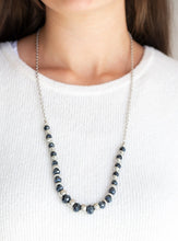 Load image into Gallery viewer, Varying in size, shiny silver beads, textured silver accents, and sparkling blue metallic crystal-like beads are threaded along an invisible wire at the bottom of a lengthened silver chain for a refined flair. Features an adjustable clasp closure.  Sold as one individual necklace. Includes one pair of matching earrings.