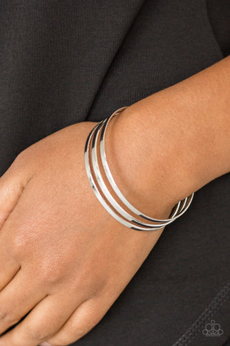 Flat silver bars race across the wrist, coalescing into a sleek cuff for a casual look.  Sold as one individual bracelet.  Always nickel and lead free.