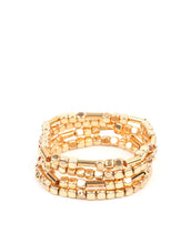 Load image into Gallery viewer,  Lightweight and flirty, two strands of golden square beads interspersed with gold cylinders, are paired with two strands of gold cubes. The four stretchy bracelets come together to create an irresistible stack of metallic mayhem.