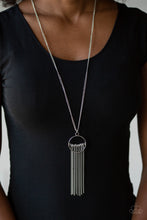 Load image into Gallery viewer, Infused with a shimmery silver chain fringe, a row of gray beads is threaded along a silver rod that is fitted in place inside the center of an airy silver ring. The colorful pendant swings from the bottom of a lengthened silver chain for a trendy tribal look. Features an adjustable clasp closure.  Sold as one individual necklace. Includes one pair of matching earrings.  Always nickel and lead free.