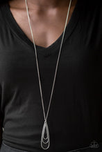 Load image into Gallery viewer, Gradually increasing in size, glistening silver teardrops coalesce into a rippling frame for an edgy look. The airy pendant swings from the bottom of a lengthened silver chain for an edgy look. Features an adjustable clasp closure.  Sold as one individual necklace. Includes one pair of matching earrings.  Always nickel and lead free.