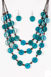 Tinted in blue finishes, shiny wooden discs trickle along shiny brown cording, creating three colorful layers below the collar. Features a button-loop closure.  Sold as one individual necklace. Includes one pair of matching