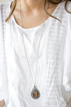 Load image into Gallery viewer, A glowing brown moonstone is pressed into an ornate teardrop frame radiating with floral detail. The dramatic pendant swings from the bottom of a lengthened silver chain for a whimsical finish. Features an adjustable clasp closure.  Sold as one individual necklace. Includes one pair of matching earrings.  Always nickel and lead free.