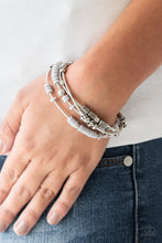 Load image into Gallery viewer, Mismatched silver accents and disc shaped gray beading slides along stretchy spring-like wires for a spunky tribal look.  Sold as one set of four bracelets.  Always nickel and lead free.