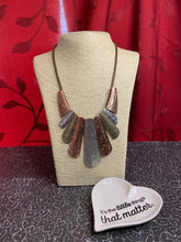 Load image into Gallery viewer, Copper, silver and brass plates featuring various hammered and filigreed textures fan out across the chest along a thick copper snake chain. The gorgeous tribal design falls gracefully below the collar into a dramatic statement piece. Features an adjustable clasp closure.  Sold as one individual necklace. Includes one pair of matching earrings.