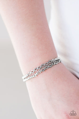 Classic silver beads are threaded along stretchy elastic bands, creating a pair of shimmery bracelets. Interweaving silver accents featuring dazzling smoky rhinestones complete the refined design.  Sold as one set of two bracelets.  Always nickel and lead free.