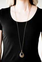 Load image into Gallery viewer, Featuring a regal teardrop shape, a faceted black bead is pressed into a larger brass teardrop, creating a whimsical pendant. Brushed in an antiqued shimmer, airy filigree climbs the bold pendant for a vintage inspired look. Features an adjustable clasp closure.  Sold as one individual necklace. Includes one pair of matching earrings.