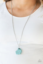 Load image into Gallery viewer, A large turquoise stone pendant hangs from a wire-wrap fitting for an artisan flair. Infused with an elongated silver chain, the earthy stone features rigid and uneven edges as if the pendant had been chipped from a cliff. As the stone elements in this piece are natural, some color variation is normal. Features an adjustable clasp closure.  Sold as one individual necklace. Includes one pair of matching earrings.  Always nickel and lead free.