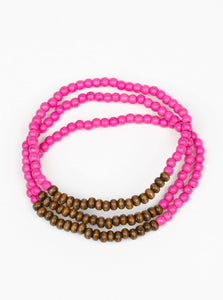 A collection of vivacious pink stones and dainty wooden beads are threaded along stretchy bands around the wrist for an earthy, layered look.  Sold as one set of three bracelets.
