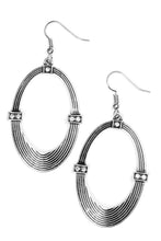 Load image into Gallery viewer, Etched in circular textures, a shimmery silver oval is encrusted in dainty white rhinestone frames for an edgy look. Earring attaches to a standard fishhook fitting.  Sold as one pair of earrings.