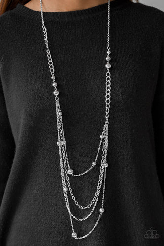 A mishmash of classic silver beading and bold chain links trickle along shimmery silver chains, creating an asymmetrically layered look. Features an adjustable clasp closure.  Sold as one individual necklace. Includes one pair of matching earrings.