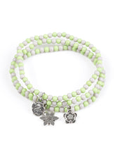 Load image into Gallery viewer, ﻿Dainty green and gray beads are threaded along stretchy elastic bands, creating colorful layers across the wrist. Brushed in an antiqued shimmer, dainty floral charms swing from the wrist for a seasonal finish.  Sold as one set of three bracelets.  