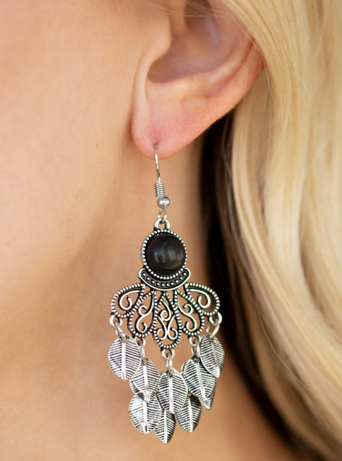 Dainty silver leaves cascade from the bottom of an ornate silver lure, creating a whimsical fringe. An earthy black stone is pressed into the top of the frame for a seasonal finish. Earring attaches to a standard fishhook fitting.  Sold as one pair of earrings.  Always nickel and lead free.