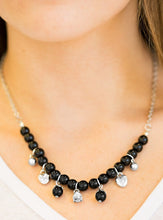 Load image into Gallery viewer, Shimmery silver heart charms, silver beads, and polished black beads swing from a row of matching black beads, creating a whimsical fringe below the collar. Featuring a regal teardrop shape, a glittery white rhinestone swings from the center for a refined finish. Features an adjustable clasp closure.  Sold as one individual necklace. Includes one pair of matching earrings.  