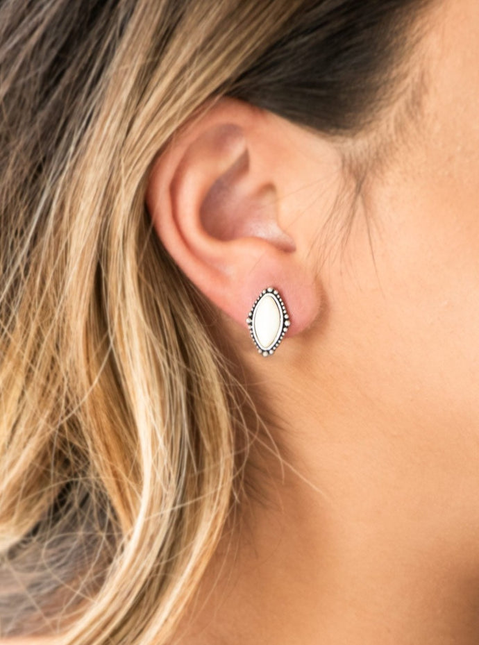 Chiseled into a tranquil marquise shape, a refreshing white stone is pressed into a studded silver frame for a seasonal look. Earring attaches to a standard post fitting.  Sold as one pair of post earrings.   Always nickel and lead free.