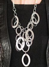 Load image into Gallery viewer, Large silver links and shimmering textured silver rings cascade below a silver chain freely, allowing for movement that makes a bold statement. Features an adjustable clasp closure.  Sold as one individual necklace.Includes one pair of matching earring.  Always nickel and lead free.