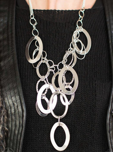 Large silver links and shimmering textured silver rings cascade below a silver chain freely, allowing for movement that makes a bold statement. Features an adjustable clasp closure.  Sold as one individual necklace.Includes one pair of matching earring.  Always nickel and lead free.