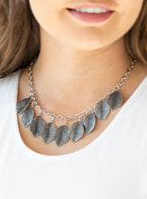 Load image into Gallery viewer, Embossed in lifelike textures, antiqued silver leaves swing from the bottom of a glistening silver chain, creating a seasonal fringe below the collar. Features an adjustable clasp closure.  Sold as one individual necklace. Includes one pair of matching earrings.  Always nickel and lead free.