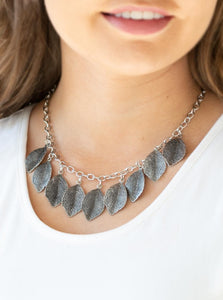 Embossed in lifelike textures, antiqued silver leaves swing from the bottom of a glistening silver chain, creating a seasonal fringe below the collar. Features an adjustable clasp closure.  Sold as one individual necklace. Includes one pair of matching earrings.  Always nickel and lead free.