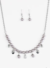 Load image into Gallery viewer, Shimmery silver heart charms, silver beads, and silver pearls swing from a row of matching silver pearls, creating a whimsical fringe below the collar. Featuring a regal teardrop shape, a glittery white rhinestone swings from the center for a refined finish. Features an adjustable clasp closure. Sold as one individual necklace. Includes one pair of matching earrings.