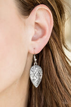 Load image into Gallery viewer, Embossed in shimmery southwestern textile patterns, a glistening silver teardrop swings from the ear for a seasonal look. Earring attaches to a standard fishhook fitting.  Sold as one pair of earrings.  Always nickel and lead free.