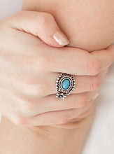 Load image into Gallery viewer, A refreshing blue bead is pressed into an ornate silver frame. Brushed in an antiqued shimmer, a pair of glistening silver flowers flank the colorful center for a summery finish. Features a dainty stretchy band for a flexible fit.  Sold as one individual ring.