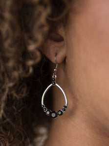 As if dipped in glitter, sparkling black rhinestones are encrusted along the bottom of a teardrop lure for a refined look. Earring attaches to a standard fishhook fitting.  Sold as one pair of earrings. 