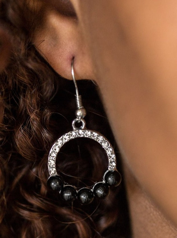 Bubbly black beads dot the bottom of a white rhinestone encrusted hoop, creating a glamorous lure. Earring attaches to a standard fishhook fitting.  Sold as one pair of earrings.