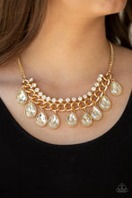 Load image into Gallery viewer, Teardrop rhinestones swing from the bottom of a bold gold chain, creating a dramatic fringe below the collar. A strand of glittery white rhinestones attach to the top of a shimmery gold chain, adding a refined flair to the flashy statement piece. Features an adjustable clasp closure.  Sold as one individual necklace. Includes one pair of matching earrings.  Always nickel and lead free.