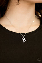 Load image into Gallery viewer, Glistening silver bars fold around a solitaire white rhinestone, creating a romantic heart pendant below the collar for a timeless look. Features an adjustable clasp closure.  Sold as one individual necklace. Includes one pair of matching earrings.  Always nickel and lead free.