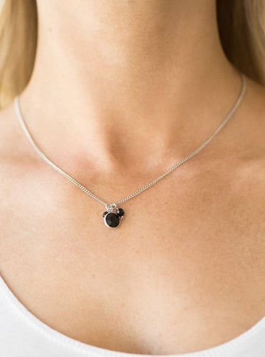 Faceted beads and a glassy black gem swing from the bottom of a shimmery silver chain, creating a dainty pendant below the collar. Features an adjustable clasp closure.  Sold as one individual necklace. Includes one pair of matching earrings.