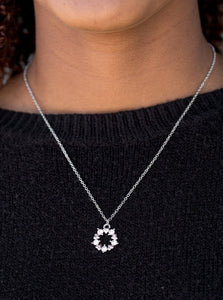 Dainty silver hearts and glittery white rhinestones join into a round dainty pendant below the collar for a romantic look. Features an adjustable clasp closure.  Sold as one individual necklace. Includes one pair of matching earrings.