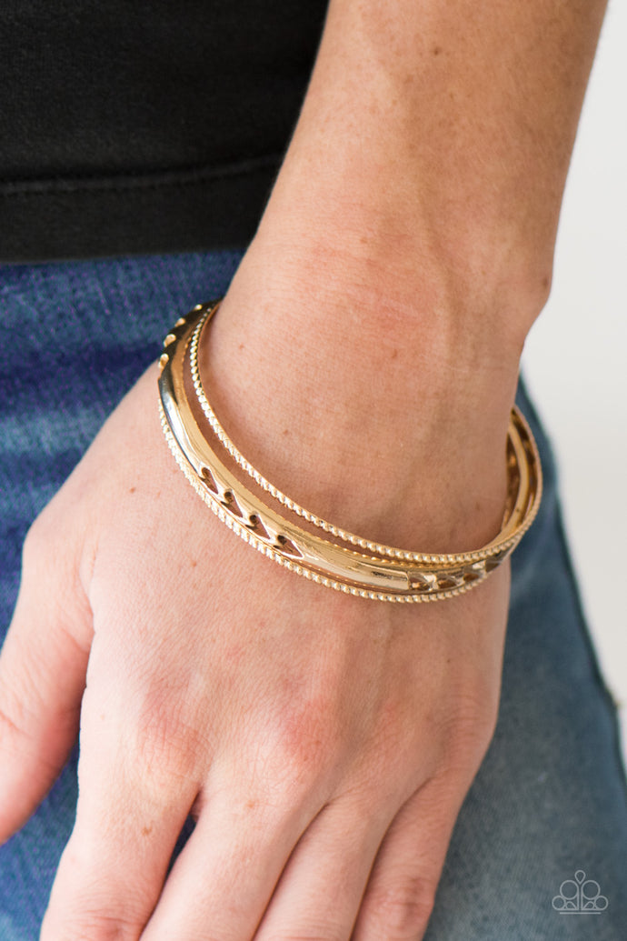 A dainty pair of textured bangles joins a glistening gold bangle stenciled in tribal-like patterns for an indigenous finish.  Sold as one set of three bracelets.  Always nickel and lead free.