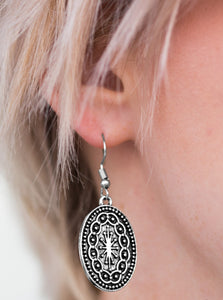 Brushed in an antiqued finish, a shimmery oval frame is embossed in a radiant pattern for a tribal inspired look. Earring attaches to a standard fishhook fitting.  Sold as one pair of earrings. 