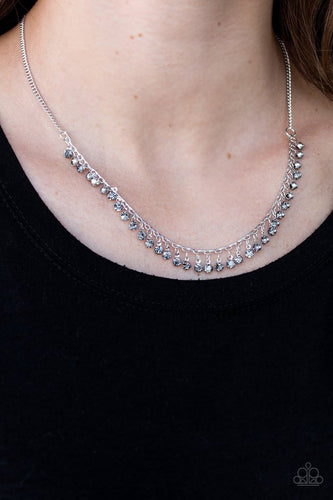 Smoky rhinestones trickle from the bottom of a silver wire, creating a glittery fringe below the collar. Features an adjustable clasp closure.  Sold as one individual necklace. Includes one pair of matching earrings.  Always nickel and lead free.