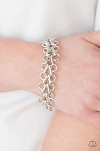 Bold silver frames link across the wrist for a fierce industrial look. Features an adjustable clasp closure.  Sold as one individual bracelet.  Always nickel and lead free.