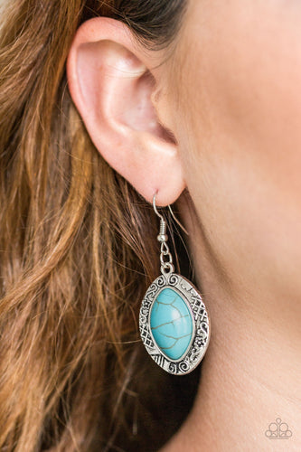 A refreshing turquoise stone is pressed into the center of a glistening silver frame radiating with floral and tribal inspired patterns for a seasonal look. Earring attaches to a standard fishhook fitting.  Sold as one pair of earrings.   Always nickel and lead free.