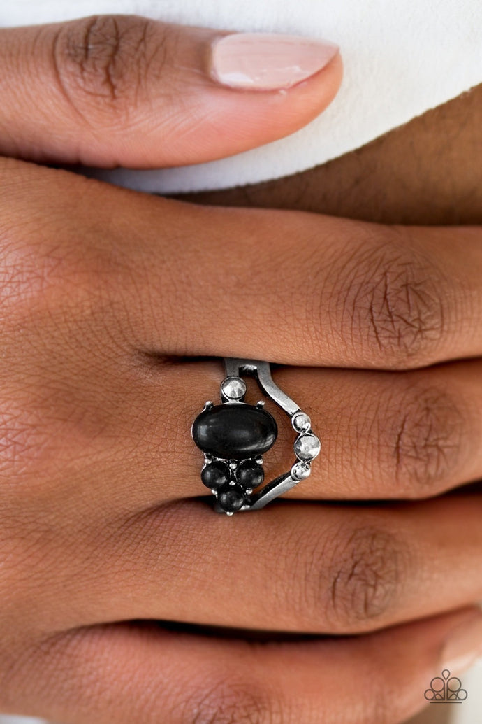 Black stone beads are haphazardly pressed into an arcing silver band for a seasonal look. Silver studs are sprinkled across the swooping bands for a shimmery finish. Features a dainty stretchy band for a flexible fit.  Sold as one individual ring.  