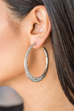 Load image into Gallery viewer, Delicately hammered in shimmery textures, a glistening silver hoop curls around the ear for a fierce fashion. Earring attaches to a standard post fitting. Hoop measures 2&quot; in diameter.  Sold as one pair of hoop earrings.  Always nickel and lead free.