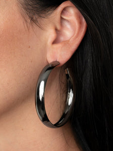 A thick gunmetal bar dramatically curls into an oversized hoop for a classic look. Earring attaches to a standard post fitting. Hoop measures approximately 2 1/2" in diameter.  Sold as one pair of hoop earrings.   Always nickel and lead free.