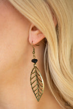Load image into Gallery viewer, An airy brass leaf swings from the bottom of an earthy black pebble, creating a seasonal lure. Earring attaches to a standard fishhook fitting.  Sold as one pair of earrings.  Always nickel and lead free.