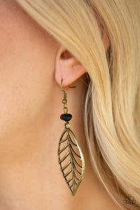 An airy brass leaf swings from the bottom of an earthy black pebble, creating a seasonal lure. Earring attaches to a standard fishhook fitting.  Sold as one pair of earrings.  Always nickel and lead free.