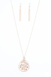 Leafy rose gold branches fan out across a glistening rose gold teardrop frame, creating a whimsical pendant at the bottom of a lengthened rose gold chain. Features an adjustable clasp closure.  Sold as one individual necklace. Includes one pair of matching earrings.  