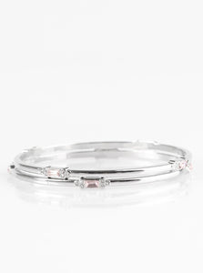 Featuring elegant round and emerald style cuts, glittery pink and white rhinestones are pressed into two shimmery silver bangles for a refined look.  Sold as one set of two bracelets.